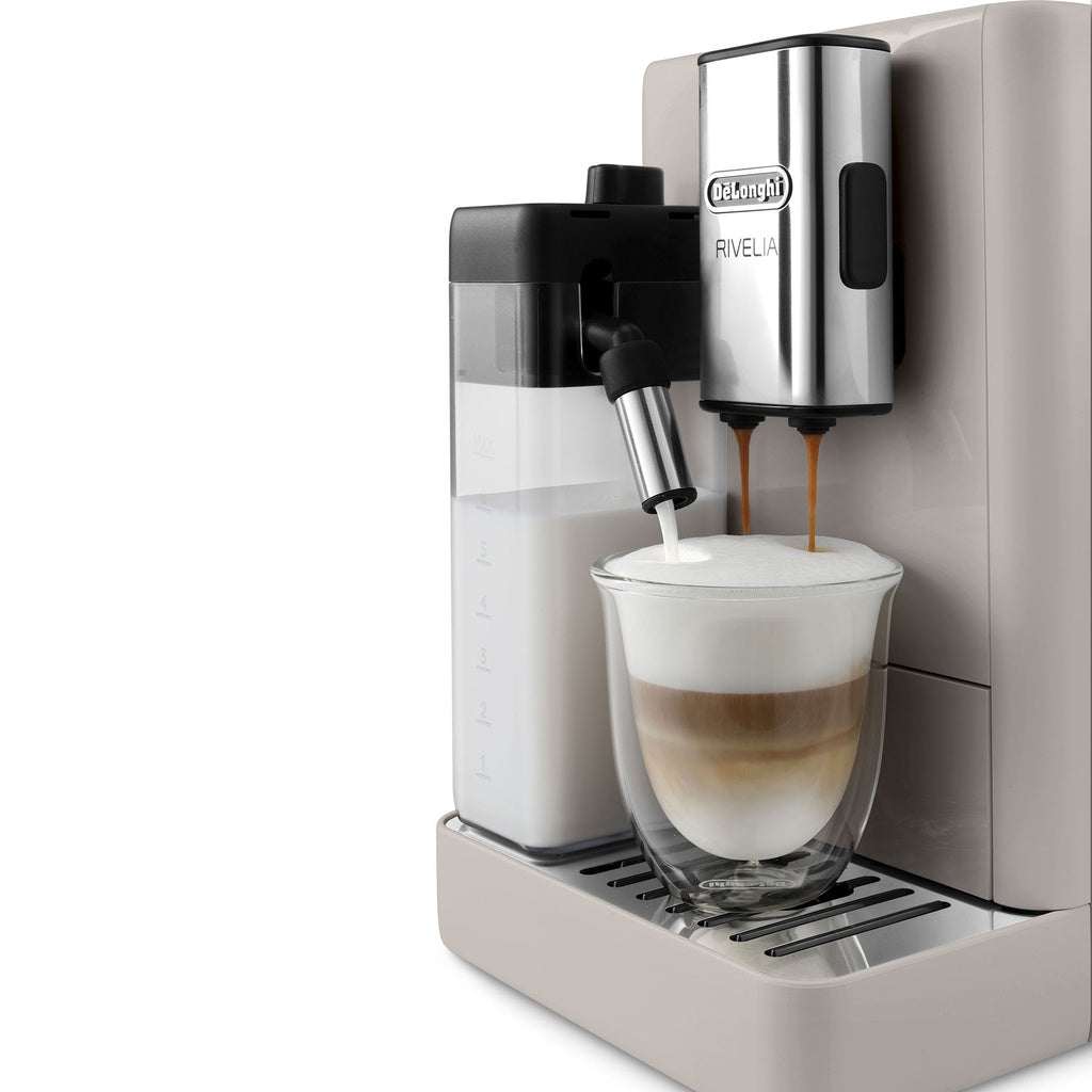 Delonghi super-automatic Rivelia coffee maker in beige, making a milk beverage with LatteCrema technology.