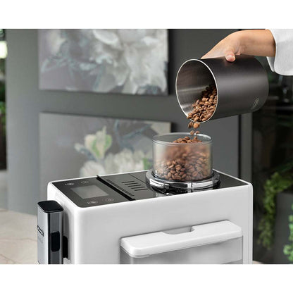 Delonghi superautomática Rivelia coffee machine with beans being poured into the hopper.